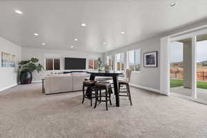 Dining room with light carpet and recessed lighting