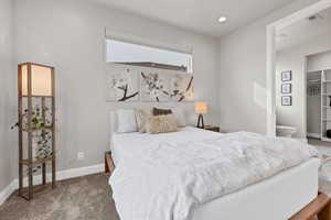 Carpeted bedroom featuring baseboards