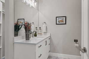 Bathroom with vanity and baseboards