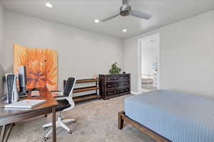 Bedroom with an office area, light colored carpet, recessed lighting, a ceiling fan, and ensuite bathroom