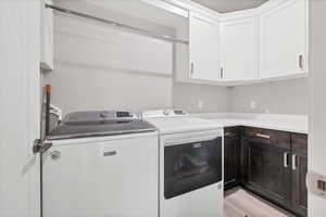 Laundry area with cabinet space and washing machine and dryer
