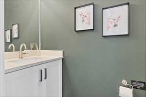 Bathroom with vanity and a textured wall