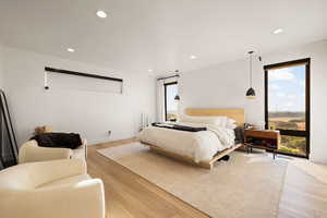 Bedroom with light wood-style flooring and recessed lighting