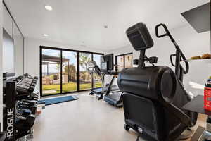 Workout area featuring finished concrete floors and recessed lighting
