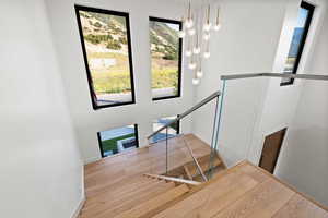 Stairway featuring a chandelier, wood finished floors, and a mountain view