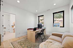 Office featuring light wood finished floors and recessed lighting