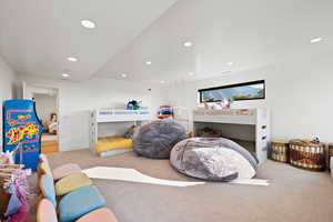 Carpeted bedroom with recessed lighting