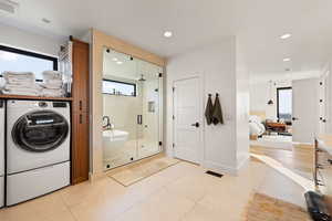 Full bath featuring a stall shower, connected bathroom, light tile patterned flooring, recessed lighting, and vanity