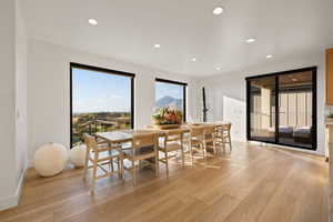 Dining area with light wood-type flooring, recessed lighting, and a mountain view