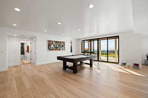 Playroom with pool table, light wood finished floors, and recessed lighting
