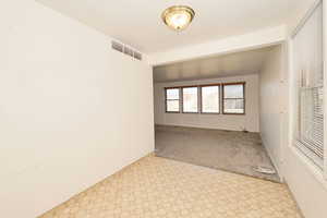 Unfurnished room with carpet flooring