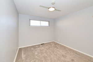Unfurnished room with carpet and a smoke detector