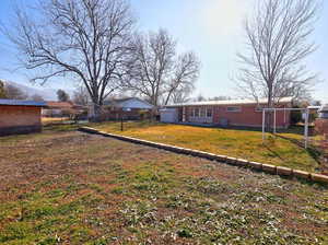 Rear view of house with brick siding and a patio area