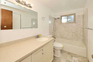 Bathroom featuring vanity and washtub / shower combination