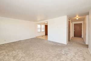 Unfurnished room with light colored carpet