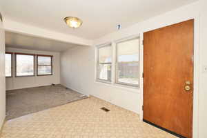 Unfurnished room featuring light carpet