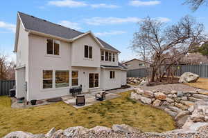 Rear view of property with a patio area, a fenced backyard, stucco siding, and roof with shingles