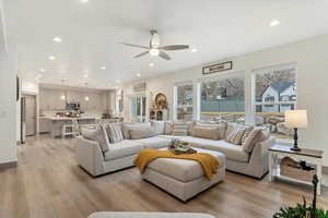 Living area with light wood-style floors, recessed lighting, and a ceiling fan