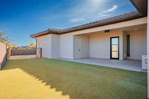 Back of house with a patio area and stucco siding
