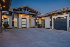 View of front of home featuring a tile roof, stucco siding, and driveway