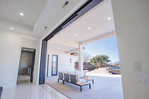 Hall with recessed lighting, a mountain view, and light tile patterned floors