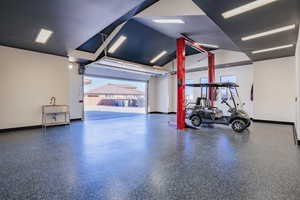 Garage featuring baseboards