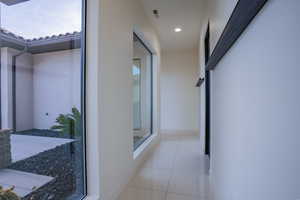 Hall featuring light tile patterned flooring and recessed lighting