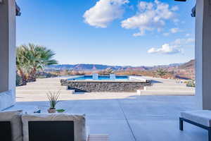 View of patio featuring a mountain view and a hot tub