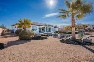 Back of house with a patio area, stucco siding, and a tiled roof
