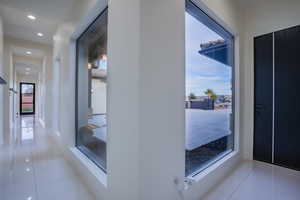 Hallway with recessed lighting and tile patterned flooring