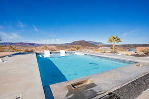 Swimming pool featuring a mountain view