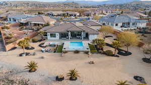 Rear view of property featuring a patio area, a fenced backyard, a mountain view, and a tiled roof