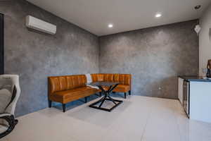 Dining area featuring light tile patterned flooring, recessed lighting, and wine cooler