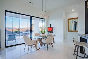 Dining space featuring a mountain view and light tile patterned floors