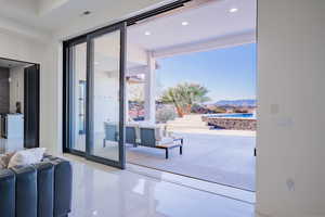 Entryway with a mountain view, tile patterned floors, and recessed lighting