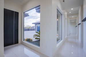 Hallway with tile patterned floors and recessed lighting