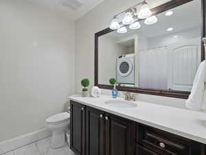 Apartment Bathroom featuring a dark wood-finish vanity with a white countertop and undermount sink