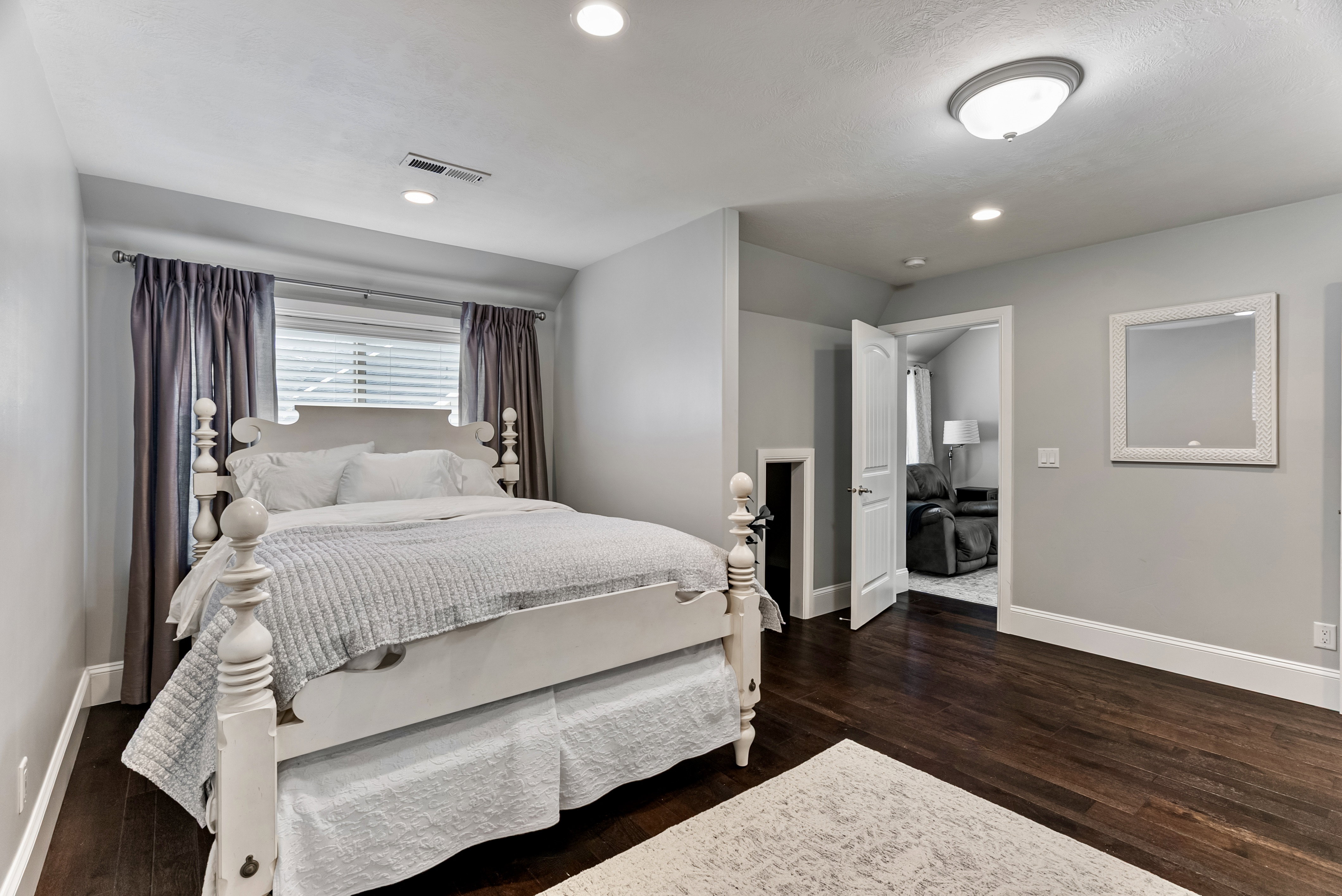 Bedroom with dark wood-type flooring and recessed lighting