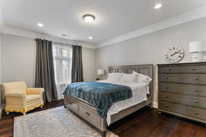 Bedroom with crown molding, dark wood finished floors, and recessed lighting