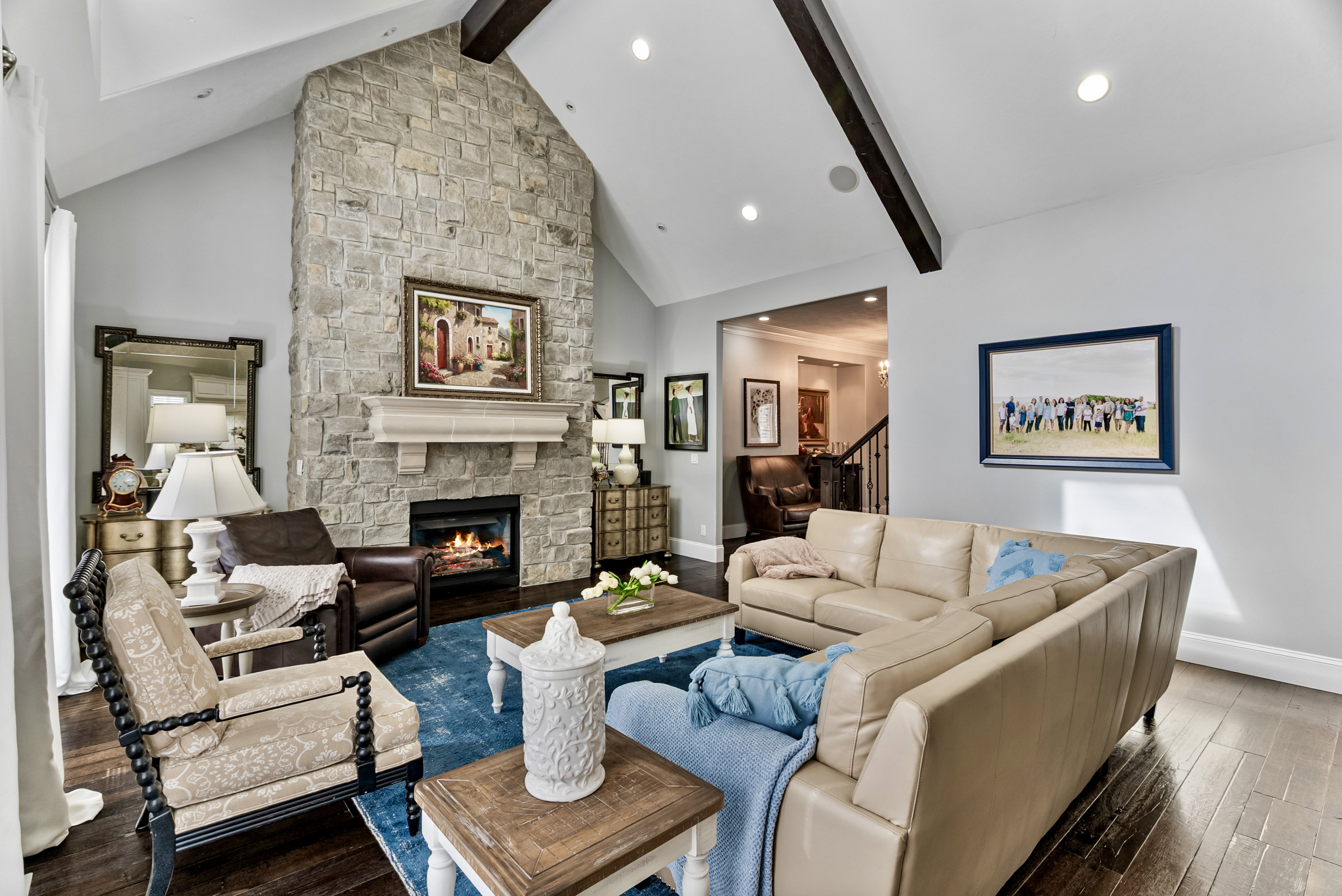 Living area with a stone fireplace and hardwood / wood-style floors