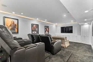 Carpeted cinema featuring crown molding and recessed lighting