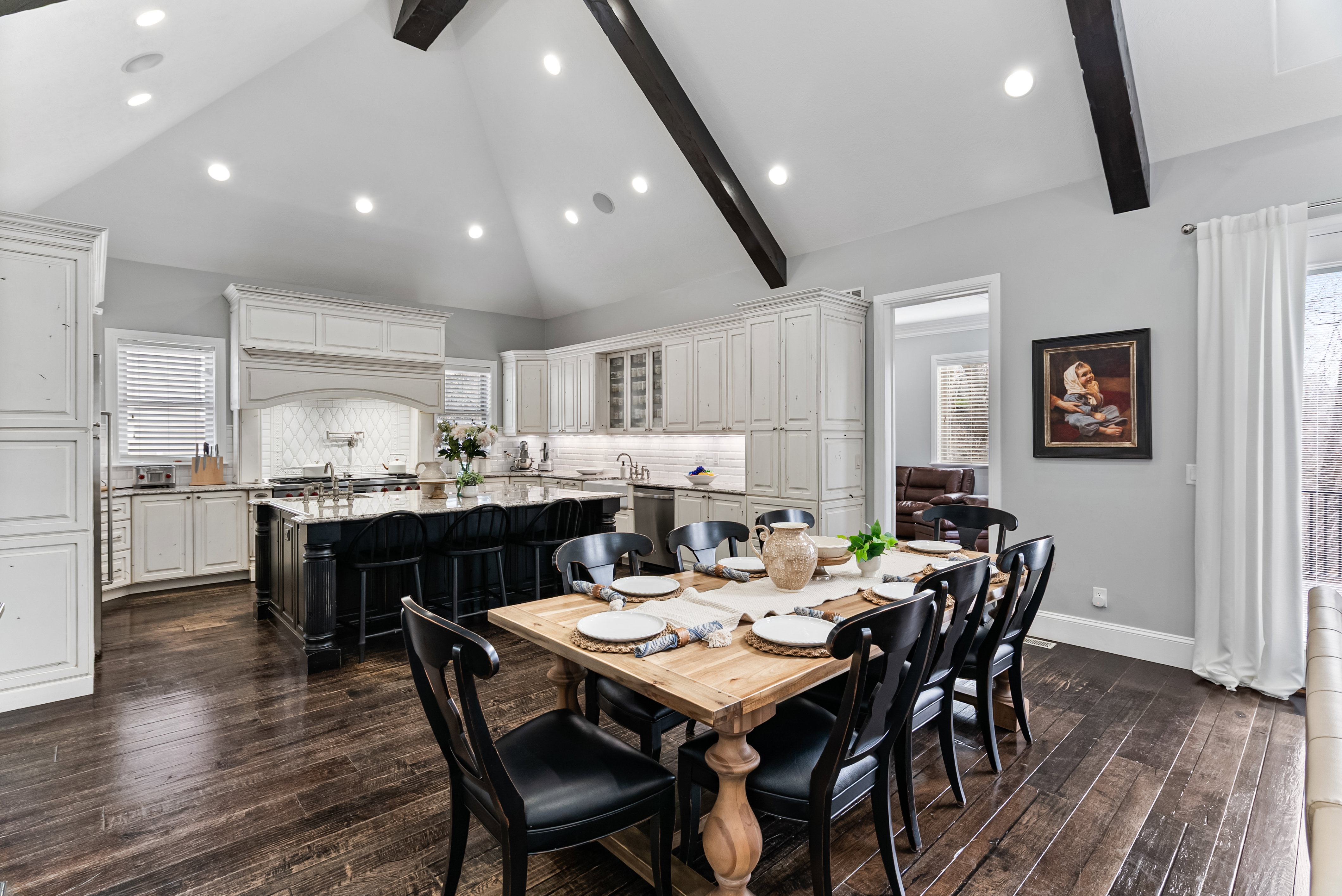 Dining space with vaulted ceiling, dark wood-style floors, and recessed lighting