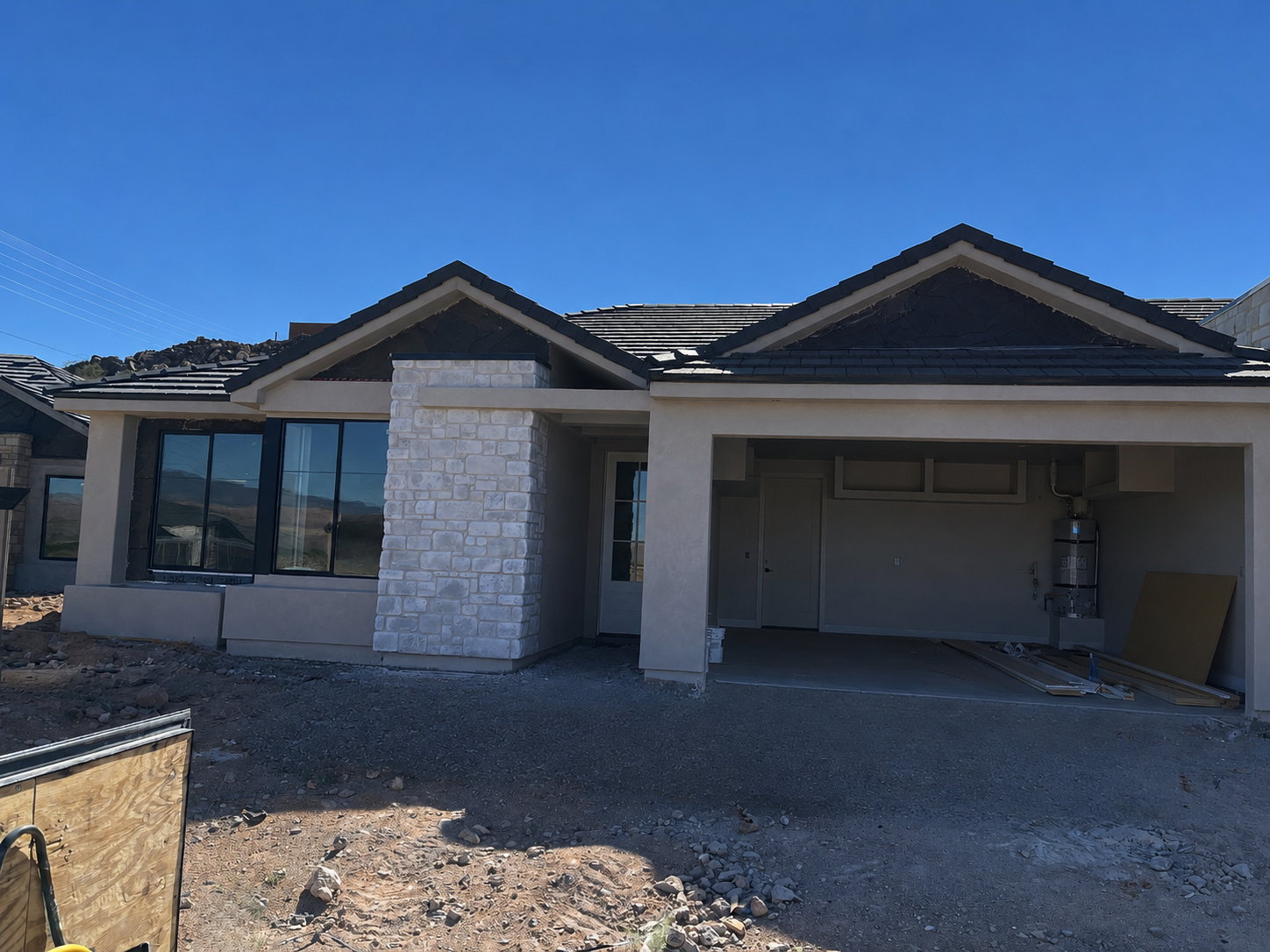 Contemporary stucco exterior with stone veneer accents