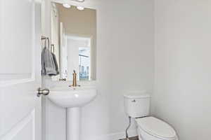 Bathroom with toilet and baseboards