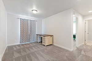 Unfurnished bedroom featuring baseboards and light colored carpet