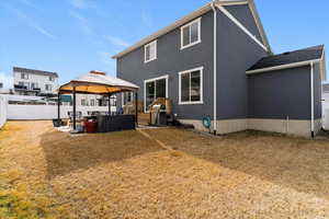 Back of property featuring a gazebo, a patio, an outdoor living space, and stucco siding
