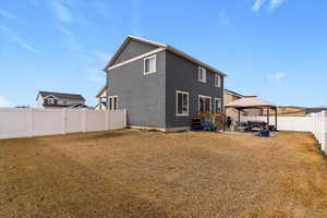 Back of property featuring a gazebo, a patio, a fenced backyard, outdoor lounge area, and stucco siding