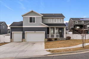 Traditional-style home with a gate, a porch, stucco siding, and concrete driveway