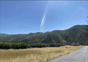 View of mountain backdrop featuring rural landscape