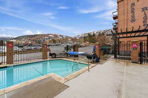 Community pool with a mountain view and a patio